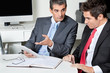 Foto: Businessmen Using Digital Tablet At Desk Businessmen Using Digital Tablet At Desk