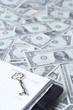 Diary with key on US paper currency note