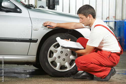 Photo: auto mechanic repairman inspecting car auto mechanic repairman inspecting car