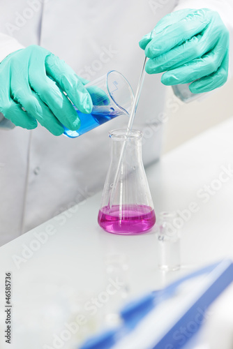 Photo: hands of researcher with laboratory glassware hands of researcher with laboratory glassware