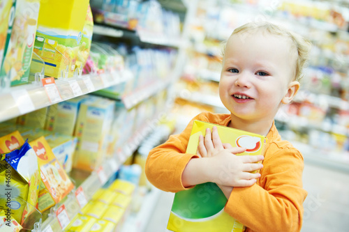 Photo: child making food shopping at grocery store child making food shopping at grocery store