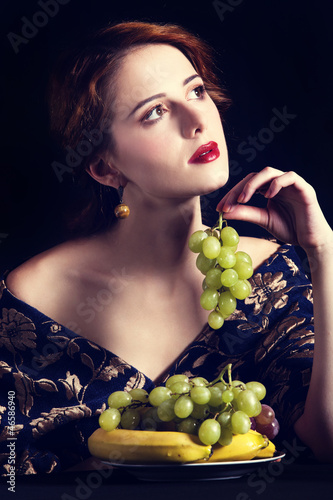 Photo: Portrait of beautiful rich women with grapes. Portrait of beautiful rich women with grapes.