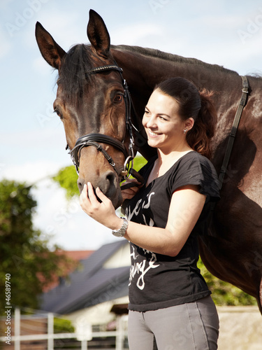 Photo: Dressage riding - woman proudly presents her horse outdoors Dressage riding - woman proudly presents her horse outdoors