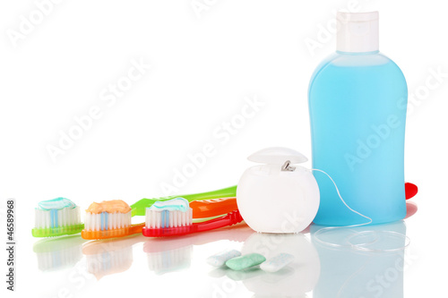Photo: Toothbrush, chewing gum and dental floss isolated on white Toothbrush, chewing gum and dental floss isolated on white
