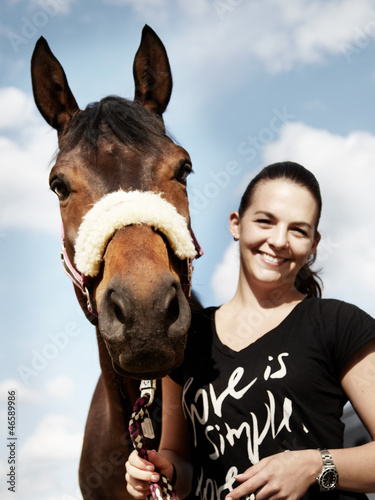 Photo: Dressage riding - woman proudly presents her horse outdoors Dressage riding - woman proudly presents her horse outdoors