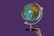 Female hand with a globe