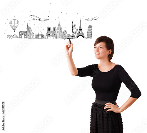 Photo: Young woman drawing famous cities and landmarks on whiteboard Young woman drawing famous cities and landmarks on whiteboard