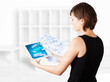 Young woman looking at modern tablet with social icons