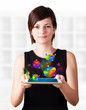 Young woman looking at modern tablet with pie charts
