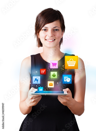 Photo: Young woman looking at modern tablet with colourful icons Young woman looking at modern tablet with colourful icons