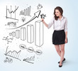 Young business woman drawing diagrams on whiteboard