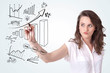 Young business woman drawing diagrams on whiteboard