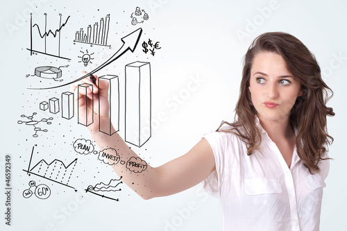 Photo: Young business woman drawing diagrams on whiteboard Young business woman drawing diagrams on whiteboard