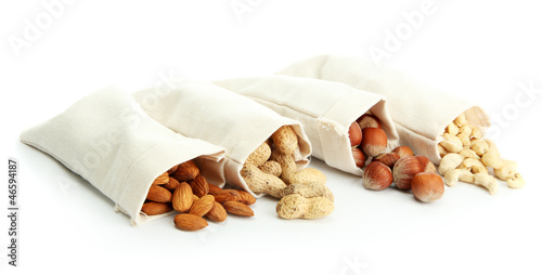 Photo: assortment of tasty nuts in bags, isolated on white assortment of tasty nuts in bags, isolated on white