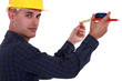 Tradesman using a measuring tape