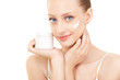 Cute woman applying cream to her face