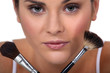 Woman holding her make-up brushes