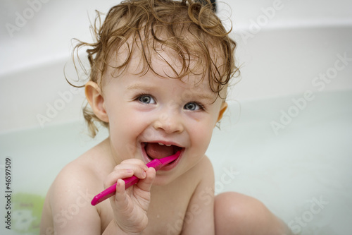 Photo: Little baby cleaning teeth in the bath Little baby cleaning teeth in the bath