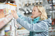 woman shopping paint at hardware store