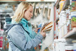 woman selecting paint at hardware store