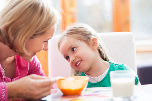 Photo: Mother feeding her daughter Mother feeding her daughter