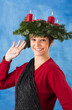 Beautiful woman with advent wreath waving
