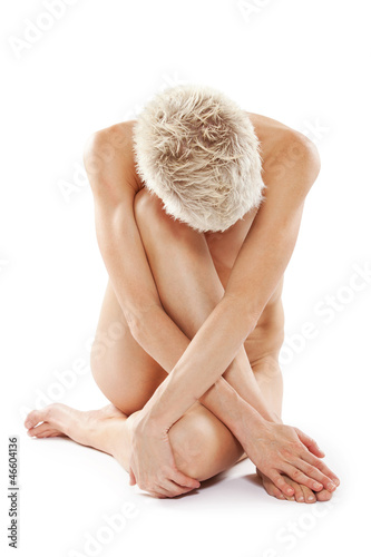 Photo: Beautiful young nude woman sitting on the floor Beautiful young nude woman sitting on the floor
