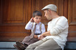 Happy father and son relaxing outdoors in city