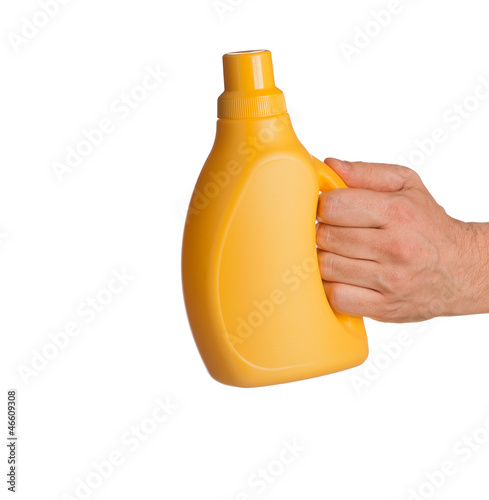 Photo: yellow cleaner bottle in hand isolated on white background yellow cleaner bottle in hand isolated on white background