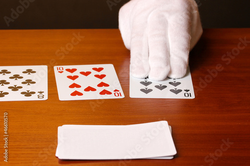 Photo: Cards and hand on brown background Cards and hand on brown background