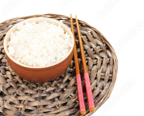 Photo: Bowl of rice and chopsticks on wicker mat isoalted on white Bowl of rice and chopsticks on wicker mat isoalted on white