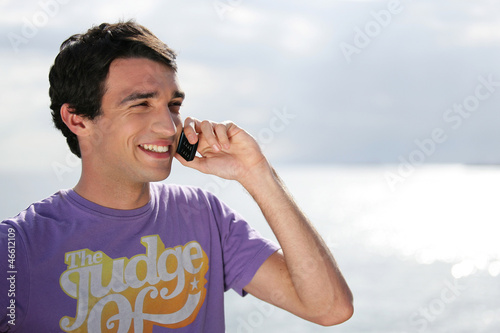 Photo: Young man on the phone Young man on the phone