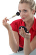 Woman applying blusher