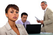 Three businesspeople reviewing budget cuts