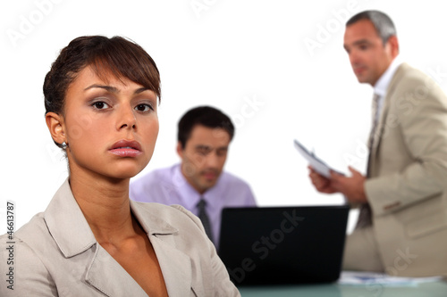 Photo: Three businesspeople reviewing budget cuts Three businesspeople reviewing budget cuts