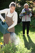 Young woman gardening with her grandmother