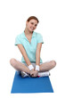 Woman sitting on an exercise mat