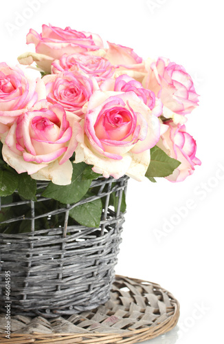 Photo: beautiful bouquet of pink roses in wicker vase, isolated beautiful bouquet of pink roses in wicker vase, isolated