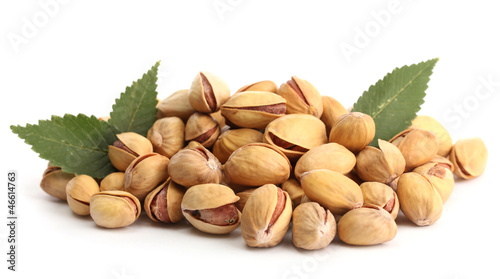 Photo: tasty pistachio nuts with leaves, isolated on white tasty pistachio nuts with leaves, isolated on white