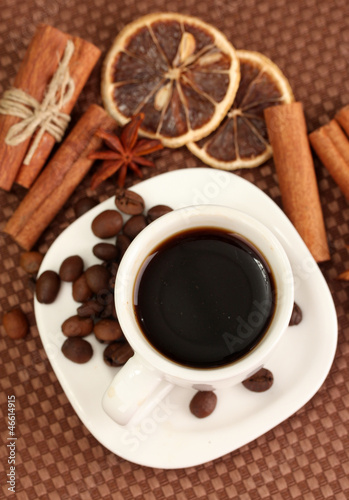 Photo: Cup of coffee on brown background Cup of coffee on brown background