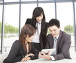 business team working in the office and watching the tablet pc