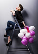 Pretty cheerful fashion retro teen girl laughing on ladder