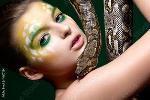 Photo: Beautiful young woman with a snake (python) - circus performance Beautiful young woman with a snake (python) - circus performance