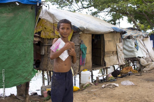 Photo: Boy in slum holding book want to go school Boy in slum holding book want to go school