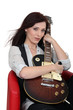 Attractive girl sitting with guitar