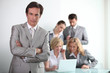 Photo: male executive with his team of colleagues male executive with his team of colleagues