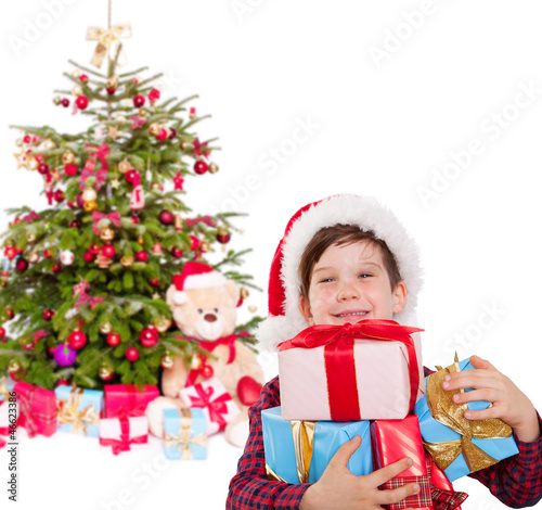 Photo: kind mit geschenken vorm christbaum kind mit geschenken vorm christbaum