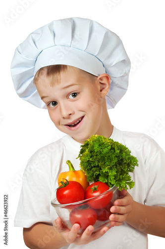 Photo: cook boy Chef is holding fresh vegetables cook boy Chef is holding fresh vegetables