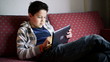 Young teenager playing games on tablet computer