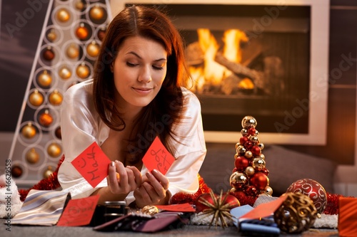 Photo: Smiling girl decide on christmas presents Smiling girl decide on christmas presents
